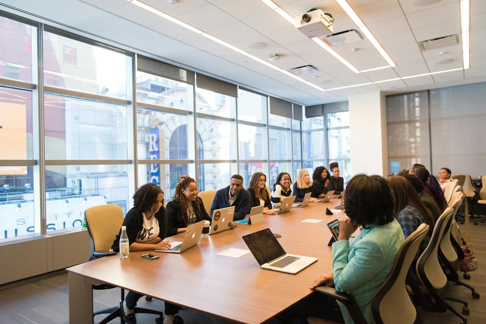 Professional team meeting in modern conference room with city views